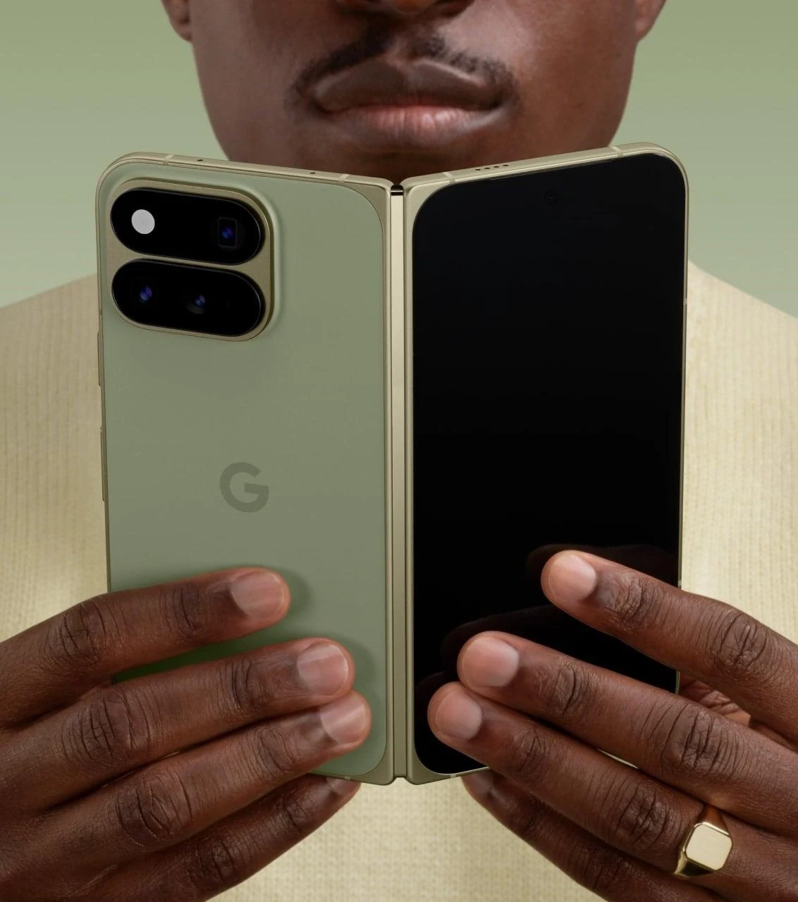 Person holding an unfolded Google Pixel 11 Pro Fold in Olive